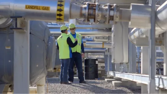 Two employees working in a Landfill Gas collection facility