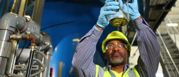 worker harvesting biogas